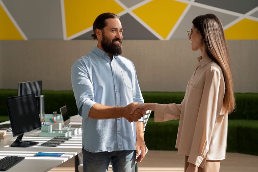 a small french bulldog wearing a black and yellow hoodie and a gold chain .